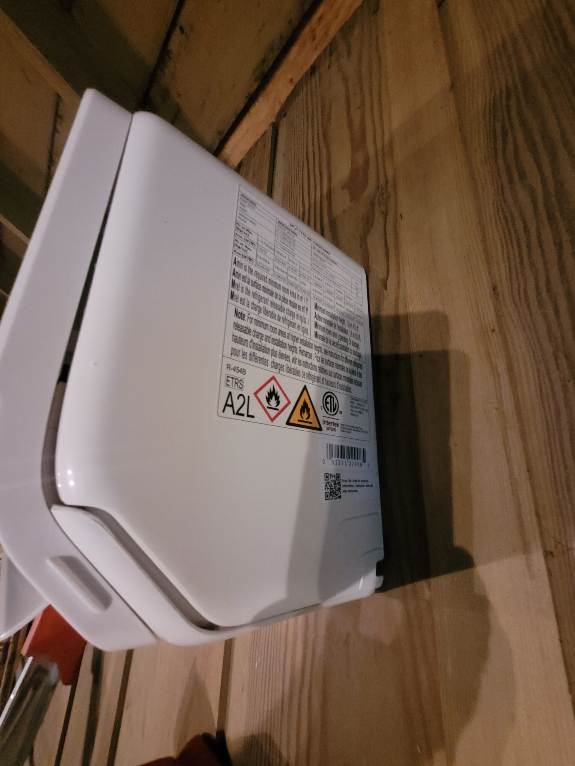 Wall-mounted mini-split indoor head showing the R-454B refrigerant identification label