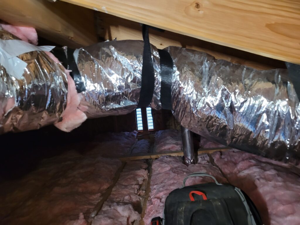 Insulated flex duct strapped to attic rafters in a Gresham home by Talon Mechanical