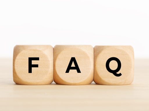 FAQ or frequently asked question concept. Wooden blocks with text on desk. Copy space