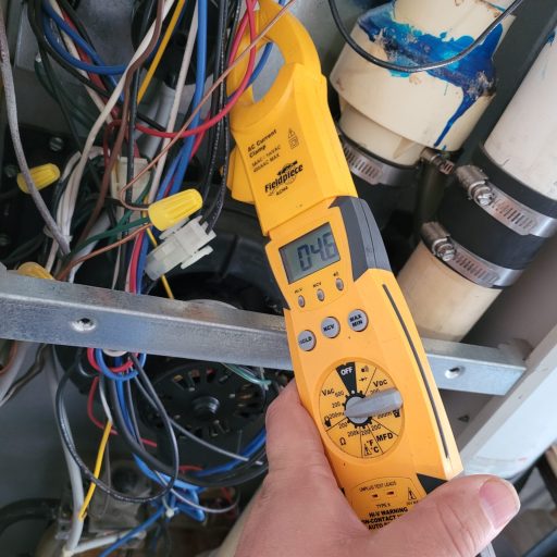 Fieldpiece ACH4 AC current clamp meter displaying 0.46 amps while testing HVAC system wiring