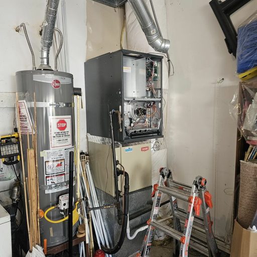 Garage utility area with Rheem water heater, Bryant furnace with open panel, ductwork, and a folding ladder